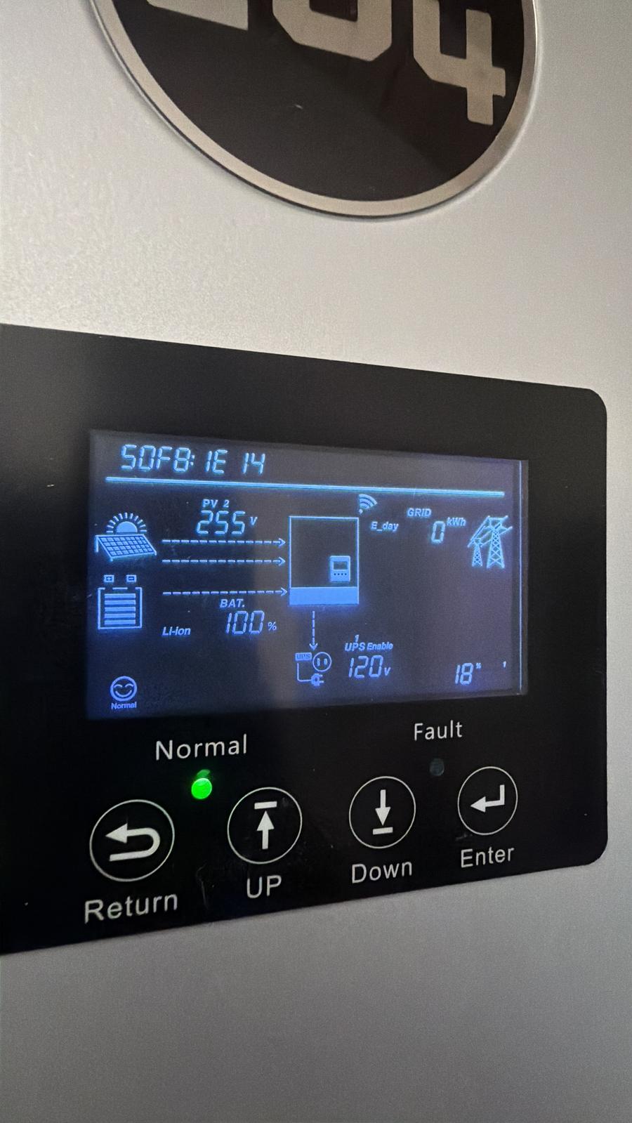 Hybrid inverter LCD screen showing live system status: battery at 100 percent, solar input, normal operation